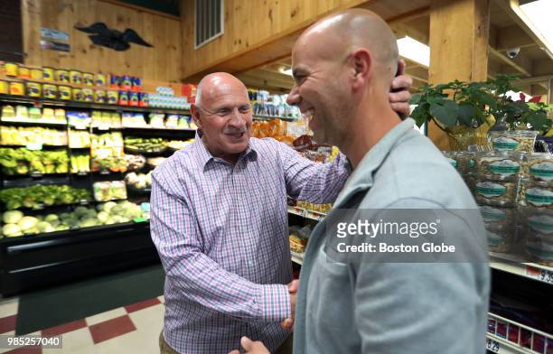 Jeffrey Carson from Mi-Amore, right, is greeted by Mark Wallerce, the owner of Winthrop Marketplace, as he arrives to pick up some food for...