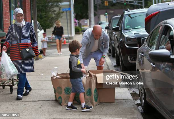 On the sidewalk outside of the Winthrop Marketplace in Winthrop, MA, Jeffrey Carson from Mi-Amore, right. And his four year old son Roman get ready...