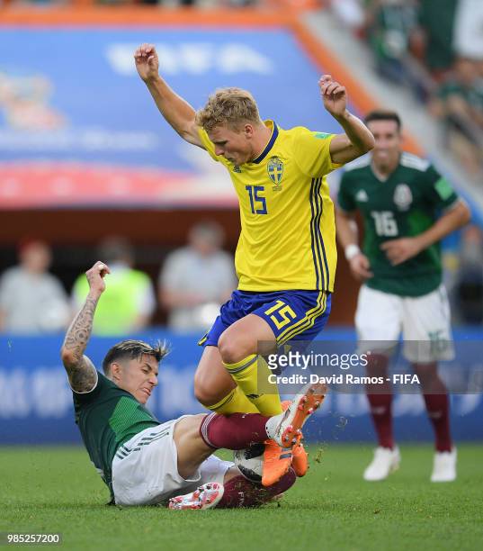 Carlos Salcedo of Mexico tackles Oscar Hiljemark of Sweden during the 2018 FIFA World Cup Russia group F match between Mexico and Sweden at...