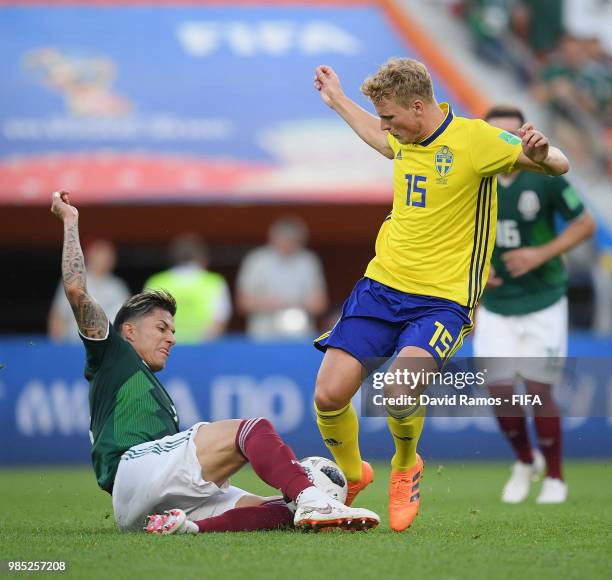 Carlos Salcedo of Mexico tackles Oscar Hiljemark of Sweden during the 2018 FIFA World Cup Russia group F match between Mexico and Sweden at...