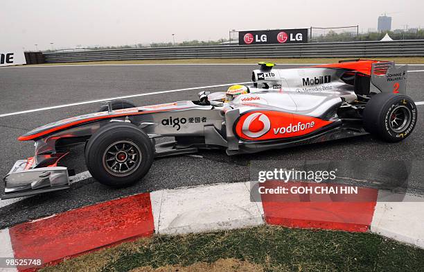 McLaren-Mercedes driver Lewis Hamilton of Britain takes his car into the pit lane during Formula One's Chinese Grand Prix in Shanghai on April 18,...