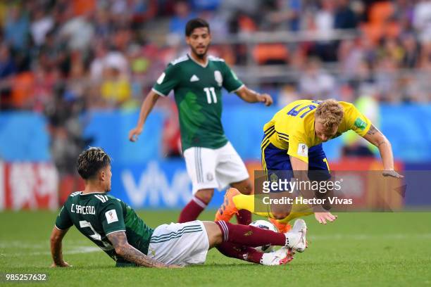 Carlos Salcedo of Mexico tackles Oscar Hiljemark of Sweden during the 2018 FIFA World Cup Russia group F match between Mexico and Sweden at...