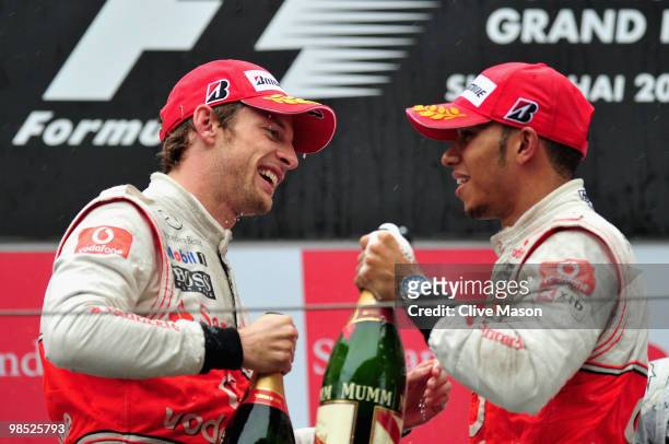 Race winner Jenson Button of Great Britain and McLaren Mercedes is congratulated on the podium by second placed team mate Lewis Hamilton of Great...