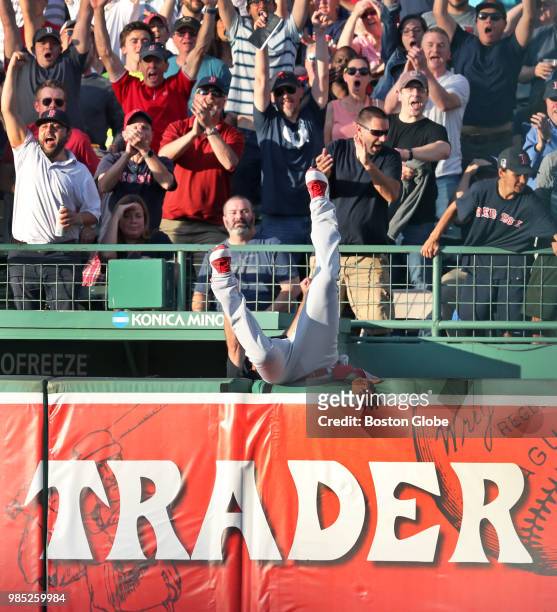 Los Angeles Angels' right fielder Michael Hermosillo flips over the wall and into the visitors' bullpen as he tries and fails to reach a bottom of...