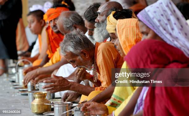 Devotees consume a meal before registering for a pilgrimage to the Hindu holy site of Amarnath, on June 27, 2018 in Jammu, India. Nearly 40,000...