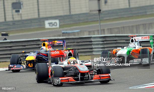 McLaren-Mercedes driver Lewis Hamilton of Britain leads Red Bull-Renault driver Sebastian Vettel of Germany and Force India-Mercedes driver Adrian...