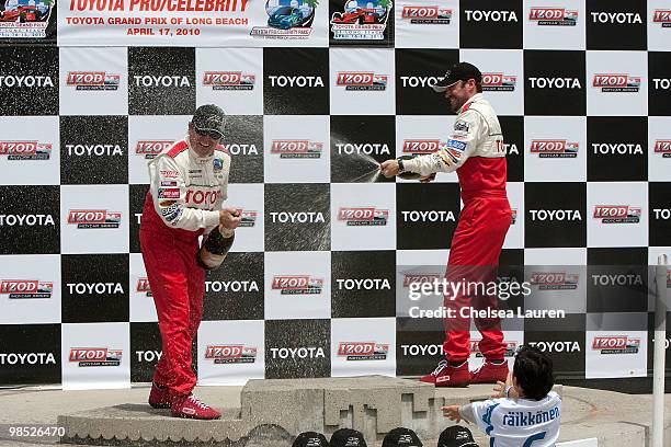 Professional racecar driver Jimmy Vasser and actor Brian Austin Green in the winner's circle at the Toyota Grand Prix Pro / Celebrity Race Day on...