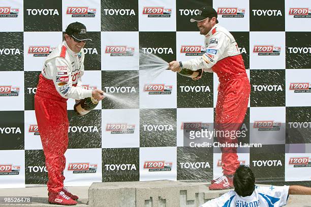 Professional racecar driver Jimmy Vasser and actor Brian Austin Green in the winner's circle at the Toyota Grand Prix Pro / Celebrity Race Day on...