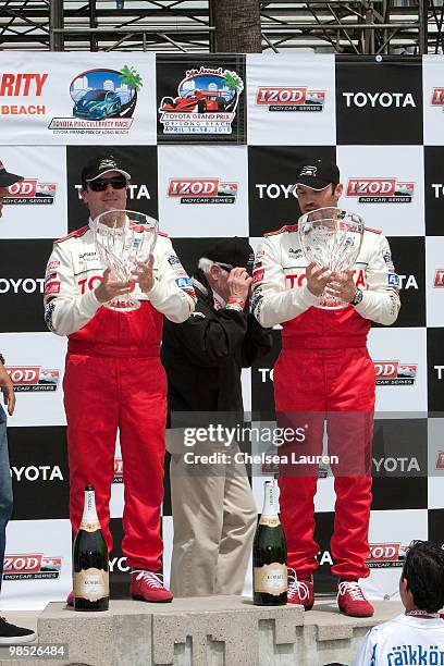 Professional racecar driver Jimmy Vasser and actor Brian Austin Green in the winner's circle at the Toyota Grand Prix Pro / Celebrity Race Day on...