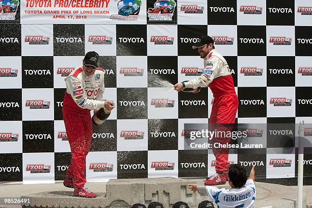 Professional racecar driver Jimmy Vasser and actor Brian Austin Green in the winner's circle at the Toyota Grand Prix Pro / Celebrity Race Day on...