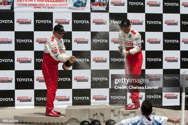 Professional racecar driver Jimmy Vasser and actor Brian Austin Green in the winner's circle at the Toyota Grand Prix Pro / Celebrity Race Day on...