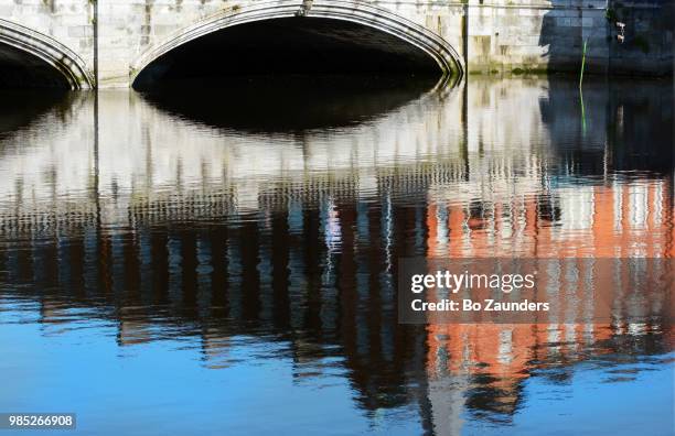 st patrick's bridge and townhouse, reflected in river lee, in cork, ireland - river lee cork stock pictures, royalty-free photos & images