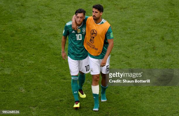 Mesut Oezil of Germany and Sami Khedira of Germany look dejected following their sides defeat in the 2018 FIFA World Cup Russia group F match between...