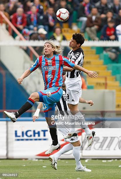 Maxi Lopez of Catania Calcio competes for the ball in the air with Emilson Cribari of AC Siena during the Serie A match between Catania Calcio and AC...