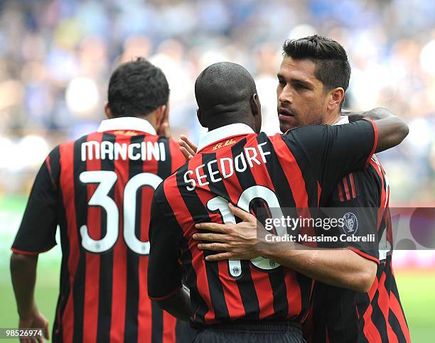 Marco Borriello of AC Milan is congratulated by Clarence Seedorf after scoring Milans's opening goal during the Serie A match between UC Sampdoria...
