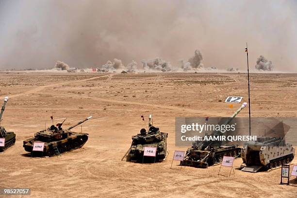 Smoke billows on the horizon as Pakistani army tanks and gunship helicopters hit their targets during a military exercise in Bahawalpur on April 18,...
