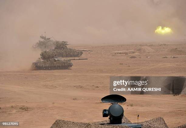 Pakistan tanks hit their targets as they take part in a military exercise in Bahawalpur on April 18, 2010. The "Azm-e-Nau-3" military exercise, which...