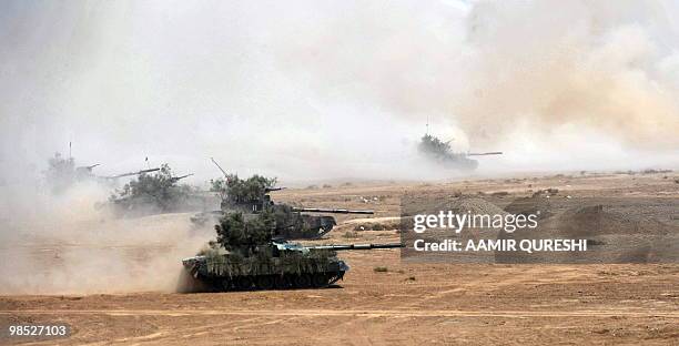 Pakistan tanks advance to hit their targets as they take part in a military exercise in Bahawalpur on April 18, 2010. The "Azm-e-Nau-3" military...
