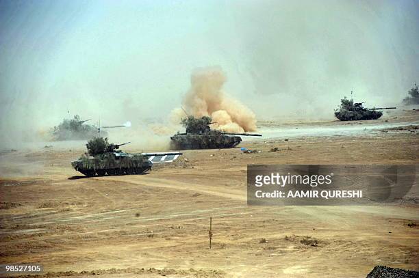 Pakistan tanks advance to hit their targets as they take part in a military exercise in Bahawalpur on April 18, 2010. The "Azm-e-Nau-3" military...