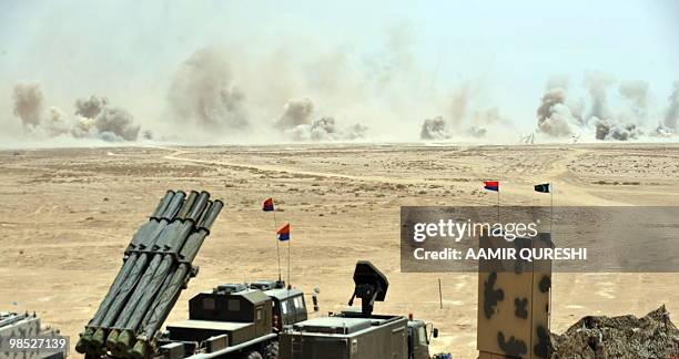 Smoke billows as Pakistani army tanks and gunship helicopters hit their targets during a military exercise in Bahawalpur on April 18, 2010. The...