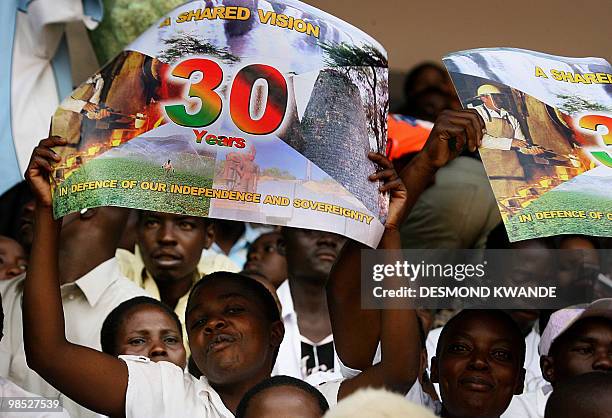 Zimbabweans cheer during independence celebrations in Harare at the National Sports Stadium on April 18, 2010. President Robert Mugabe issued an...
