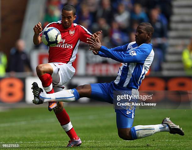 Theo Walcott of Arsenal is fouled by Titus Bramble of Wigan Athletic during the Barclays Premier League match between Wigan Athletic and Arsenal at...