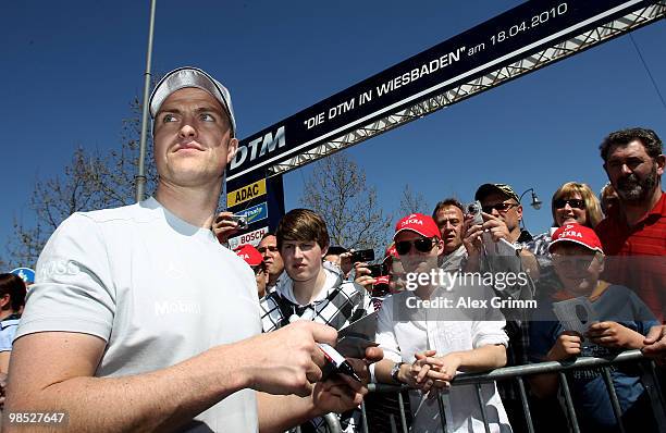 Mercedes driver Ralf Schumacher signs autographs during the presentation of the German Touring Car Championship DTM in front of the Kurhaus on April...