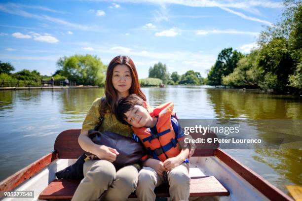 passengers in a rowing boat. - peter lourenco stock-fotos und bilder