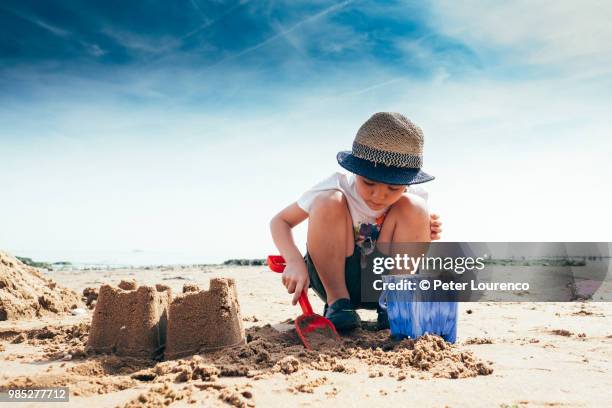 building a sandcastle - bucket and spade stock pictures, royalty-free photos & images