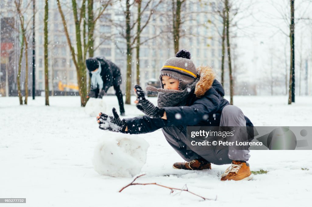 Boy building a snowman