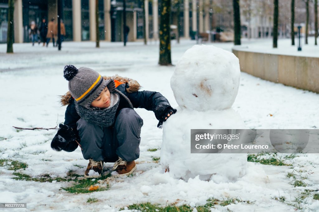 Boy building a snowman