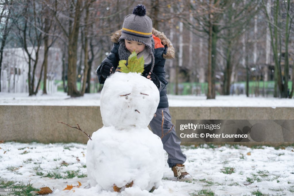 Boy building a snowman