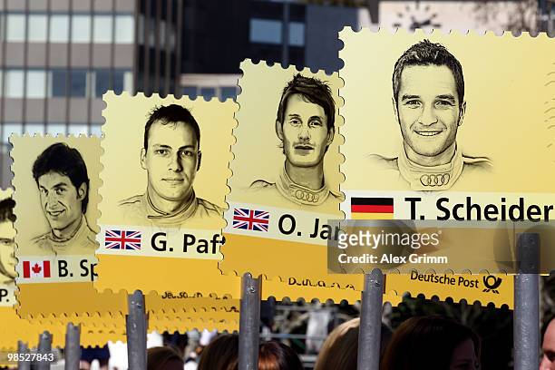 Grid girls hold up signs with the names of this year's drivers during the presentation of the German Touring Car Championship DTM in front of the...