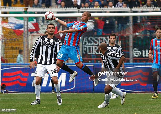 Takayuki Morimoto of Catania Calcio battles for the ball with Ferreira Reginaldo of AC Siena during the Serie A match between Catania Calcio and AC...