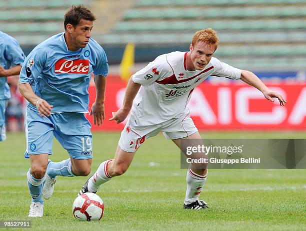 German Dennis of Napoli and Alessandro Gazzi of Bari in action during the Serie A match between AS Bari and SSC Napoli at Stadio San Nicola on April...