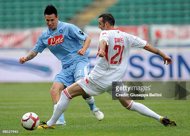 Marek Hamsik of Napoli and Alessandro Parisi of Bari in action during the Serie A match between AS Bari and SSC Napoli at Stadio San Nicola on April...