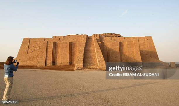 File picture daetd February 4, 2010 shows a visitor taking pictures of the stepped Ziggurat temple, a three-tiered edifice dating back to 2113 BC, in...