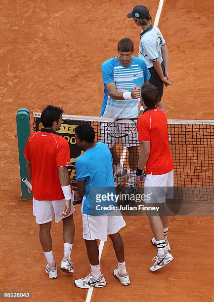 Nenad Zimonjic of Serbia and Daniel Nestor of Canada shake hands with Max Mirnyi of Belarus and Mahesh Bhupathi of India after Mahesh retired early...