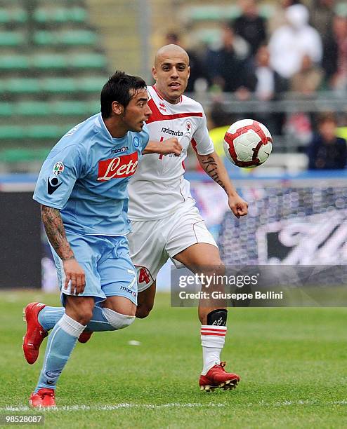 Ezequiel Lavezzi of Napoli and Sergio Almiron of Bari in action during the Serie A match between AS Bari and SSC Napoli at Stadio San Nicola on April...