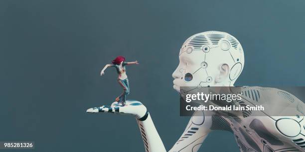 giant female cyborg holds human woman in palm of hand and blows on her with puckered lips and puffed cheeks - blowing a kiss imagens e fotografias de stock