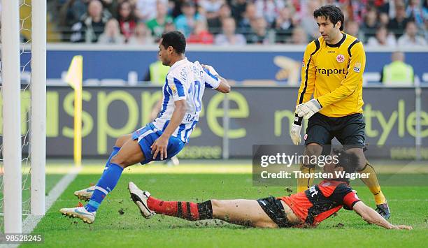 Raffael of Berlin scores his team's second goal while goalkeeper Oka Nikolov of Frankfurt and a team mate look on during the Bundesliga match between...