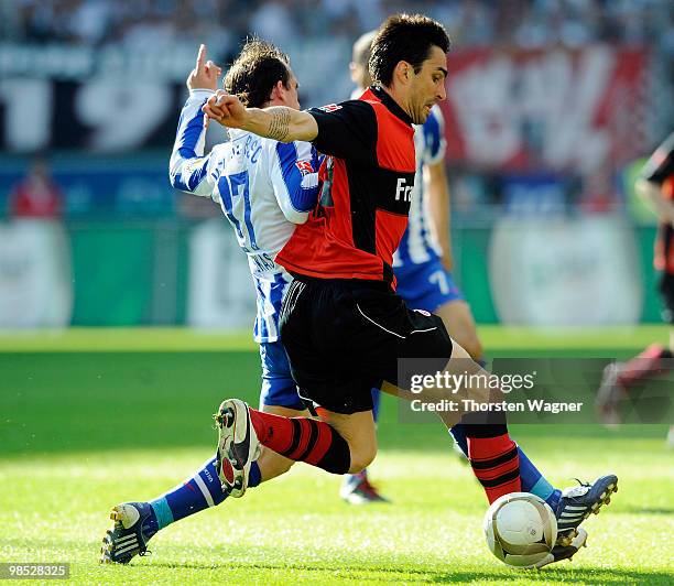 Chris of Frankfurt battles for the ball with Theofanis Gekas of Berlin during the Bundesliga match between Eintracht Frankfurt and Hertha BSC Berlin...