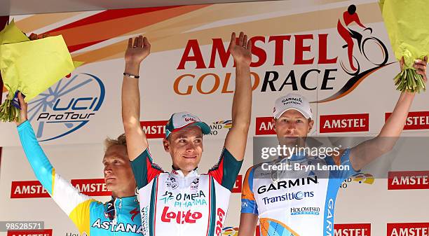 Enrico Gasparotto of Italy and Astana, Philippe Gilbert of Belgium and Omega Pharma-Lotto, Ryder Hesjedal of Canada and Garmin stand on the podium...