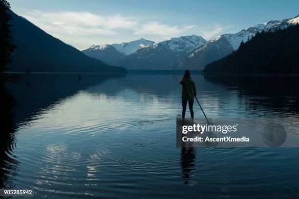 woman paddling on a stunning mountain lake - coast ranges stock pictures, royalty-free photos & images