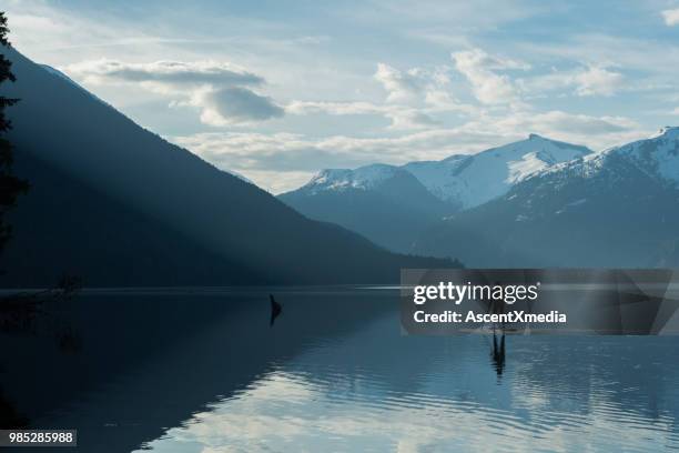 woman paddling on a stunning mountain lake - british columbia coast mountains stock pictures, royalty-free photos & images