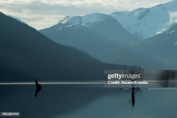 woman paddling on a stunning mountain lake - coast ranges stock pictures, royalty-free photos & images