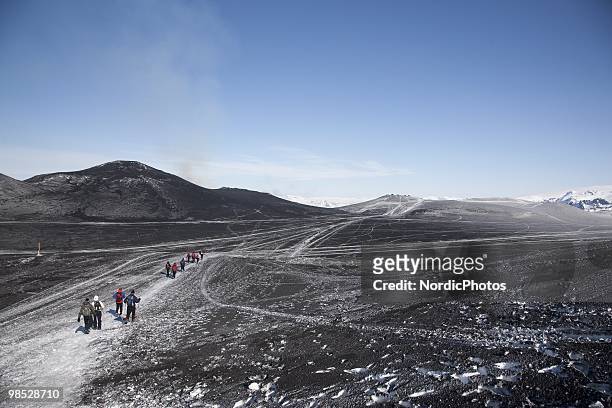 Tourists hike to see the volcanic eruption at the Fimmvorduhals area between the glaciers Eyjafjallajokull and Myrdalsjokull, approximately 125 km...