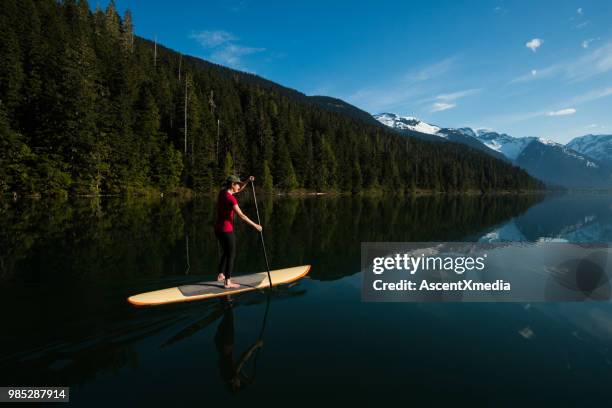 woman paddling on a stunning mountain lake - coast ranges stock pictures, royalty-free photos & images
