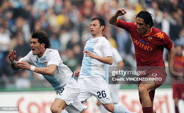 Roma's forward Luca Toni clashes with Lazio's defender Guglielmo Stendardi during their Serie A football match at Olympic stadium in Rome on April...