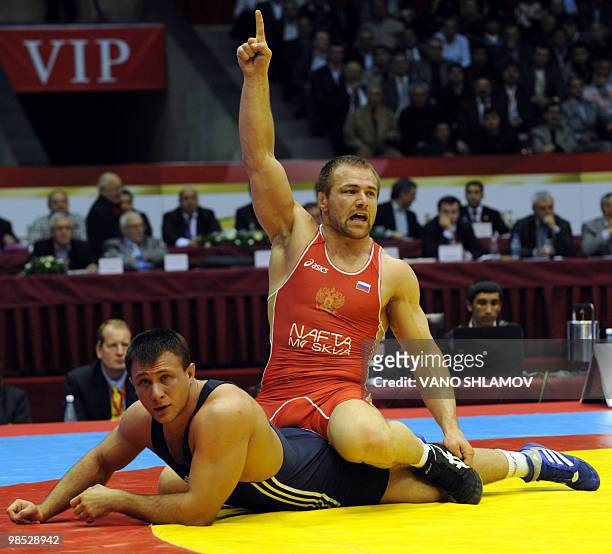 Russian Aslanbek Khushtov competes for the gold with Belarusian Tsimafei Dzeinichenka during men's Free Style Wrestling 96 kg event at the Senior...